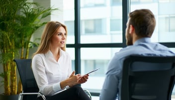 interviewing man and woman with a plant