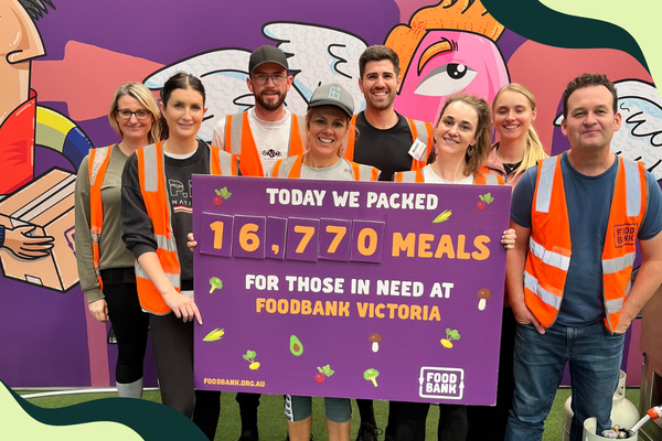six degrees team holding a sign saying today we packed 16,770 meals for those in need at foodbank australia
