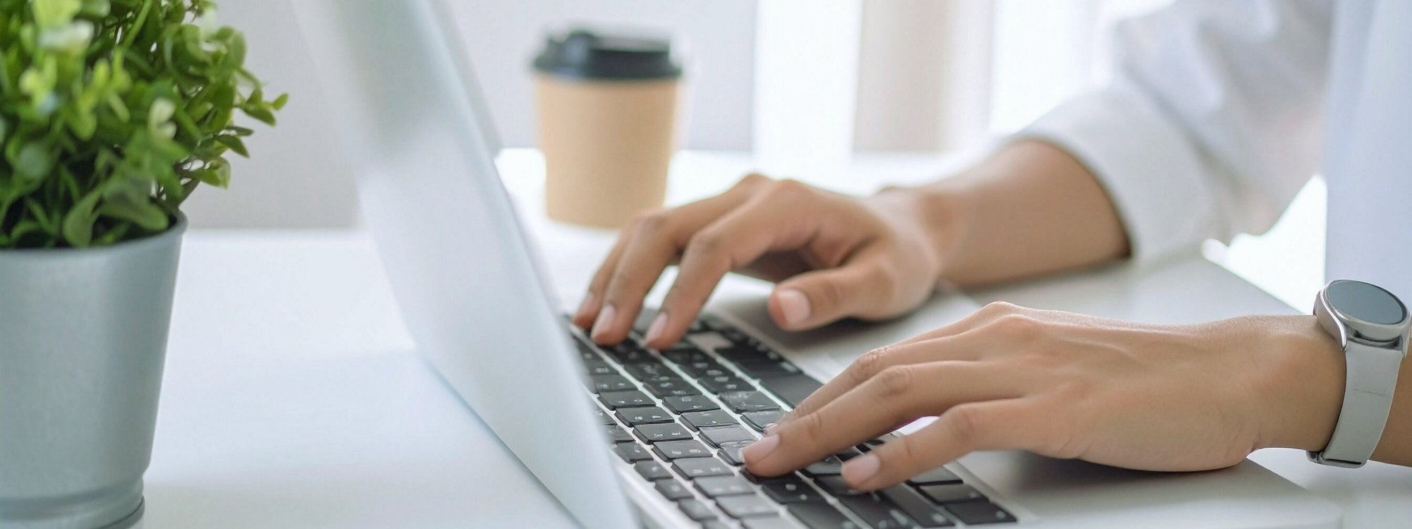 man typing on a laptop
