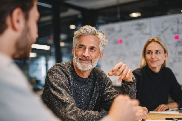 three people talking in an office