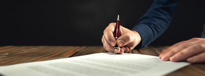 Professional signing a policy document