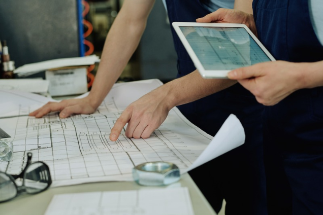 people reviewing a sitemap and an ipad