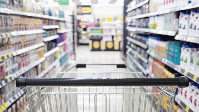 image of a shopping trolley in a supermarket isle