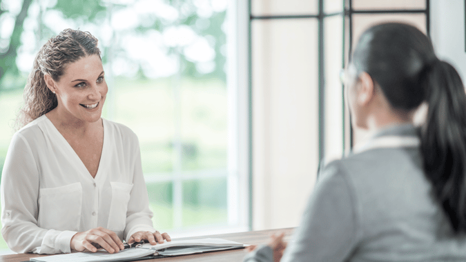 two women talking at an interview