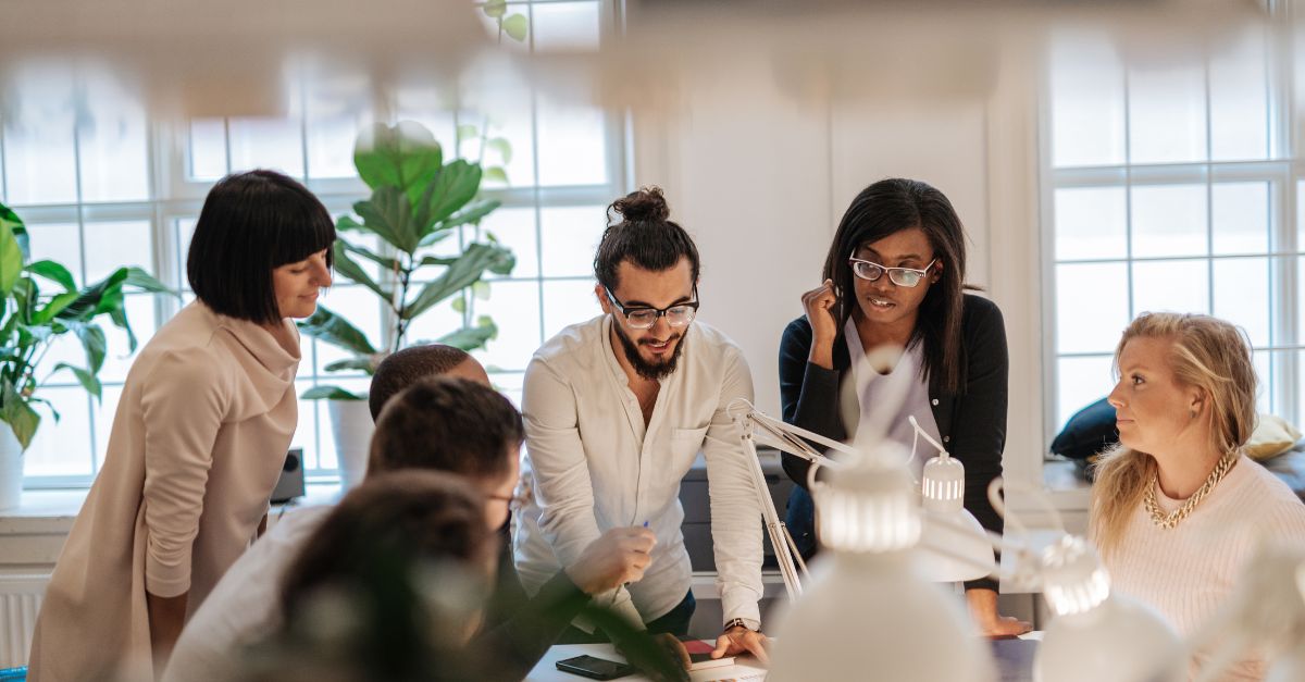 Employees working together around a table in a modern office