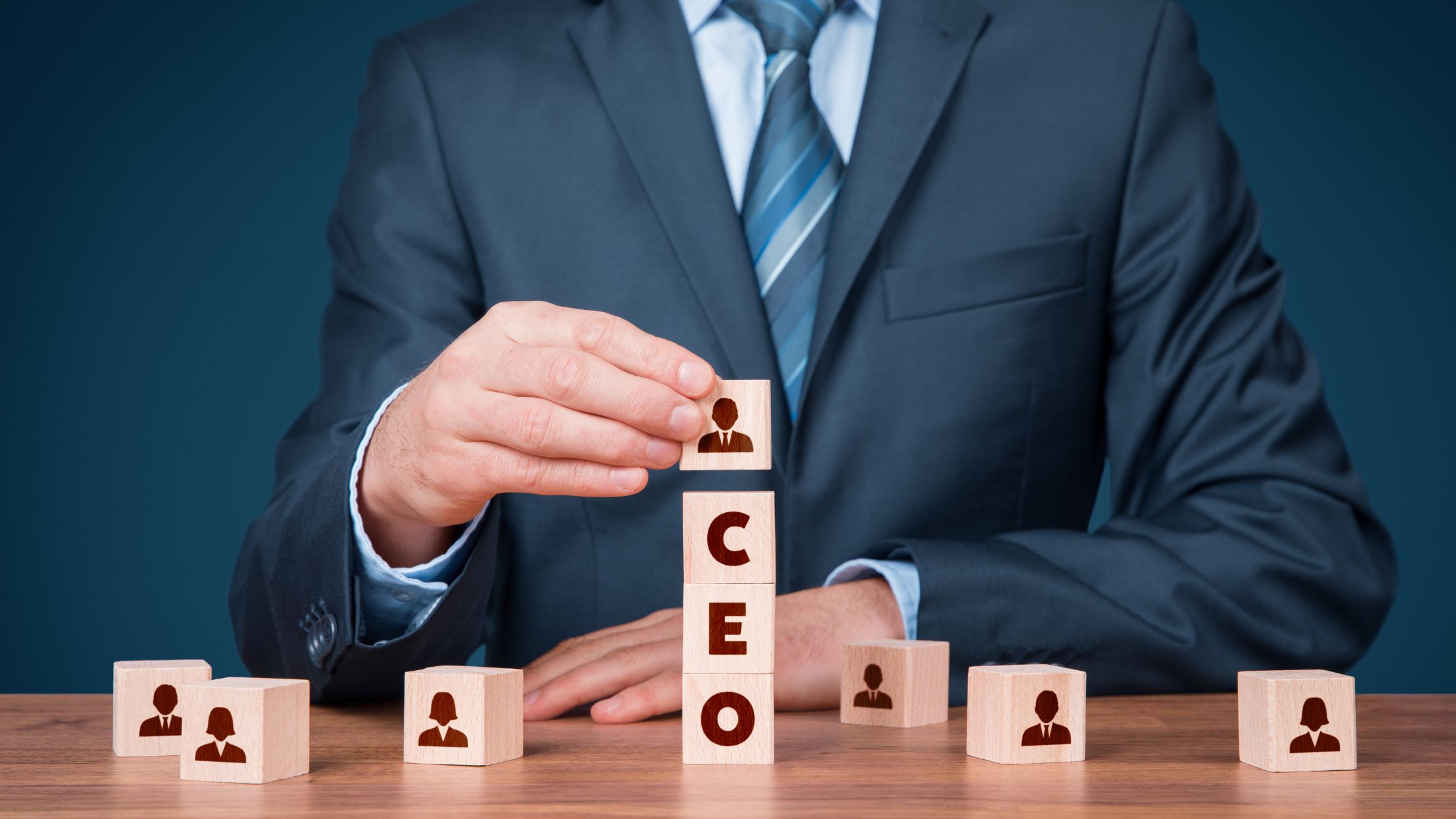 image of a man putting wooden cubes on top of each other saying CEO
