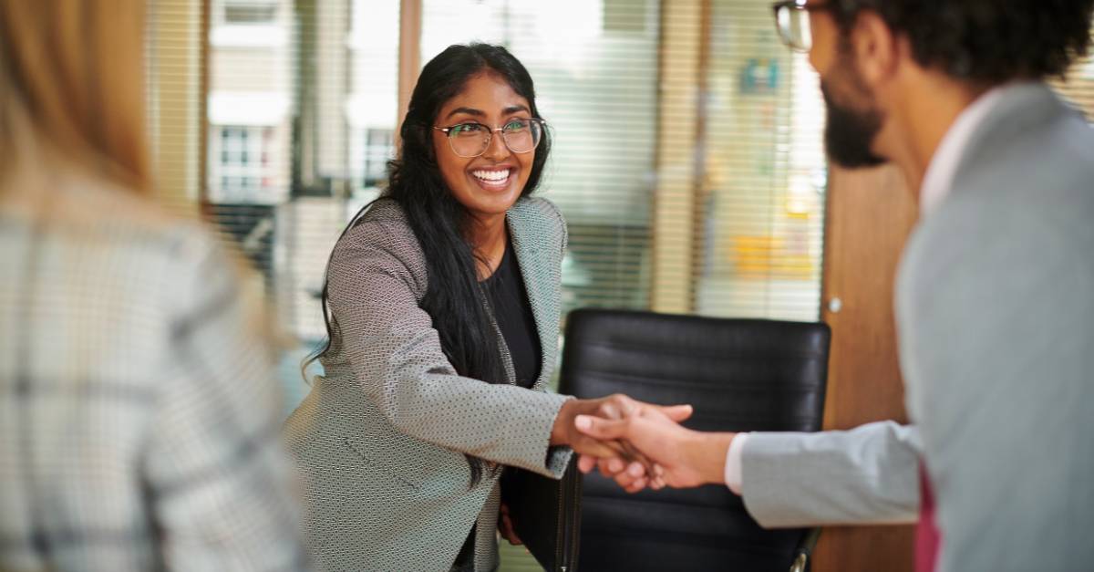 Woman shaking hands with a recruiter in an office