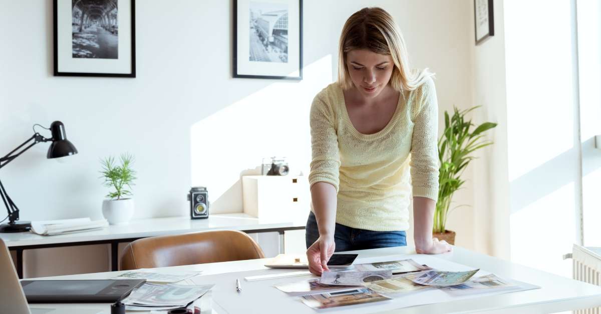 Woman arranging images on desk