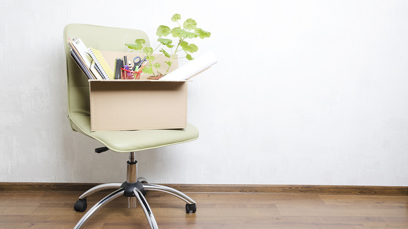 box of belongings on desk chair