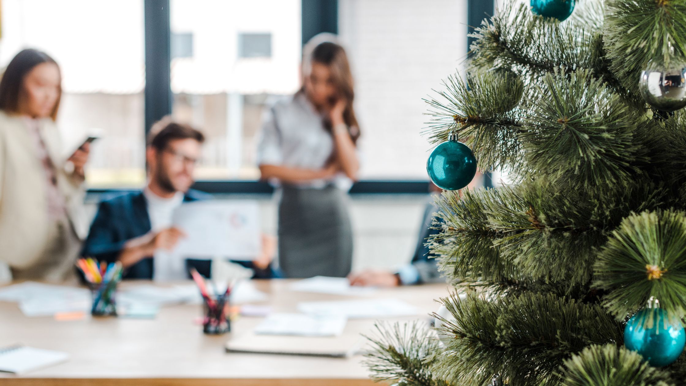 Christmas tree in office in front of employees